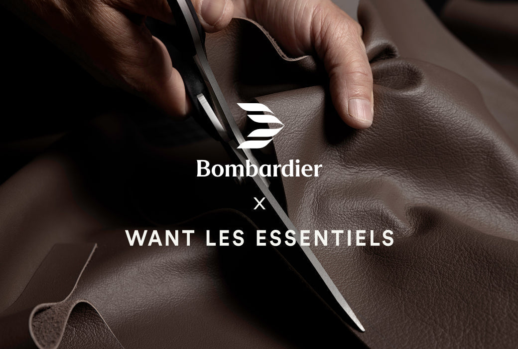 Close up on artisan's hands cutting a piece of fine leather with scissors. 